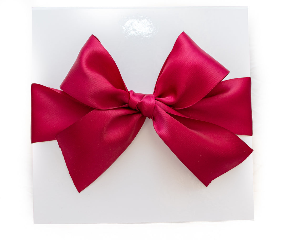 Pink gift ribbon bow. Pink red satin ribbon with knotted bow gift